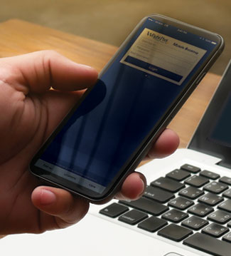 Hand using a cell phone. Mobile and online banking callout