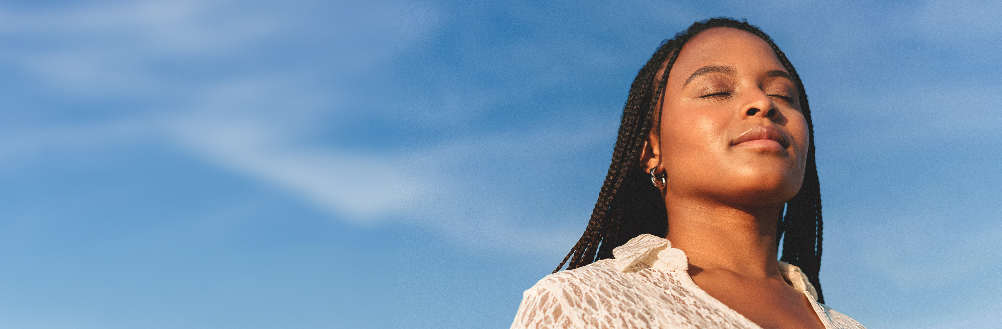 African American Woman with blue sky behind her