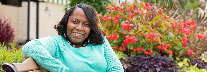 Woman sitting outside on a bench