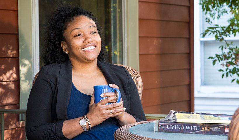 Woman drinking coffee on a porch