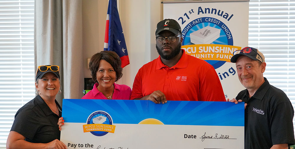 Robert K. receiving check from Sunshine Community Fund