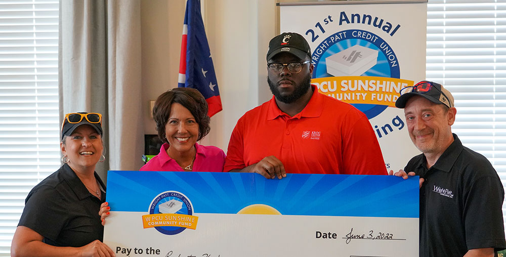 Robert K. receiving check from Sunshine Community Fund