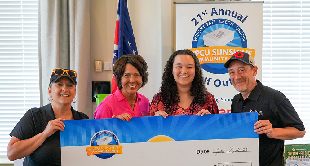 Dezerae W. receiving check from Sunshine Community Fund